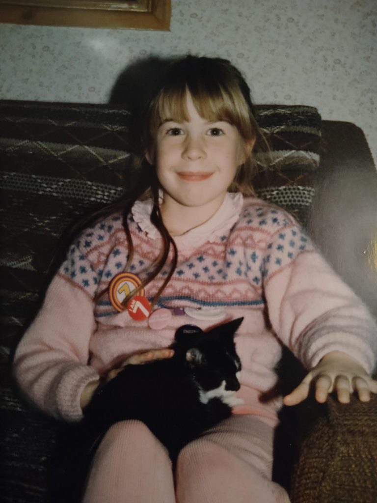 Me on my 7th birthday with Jess the kitten